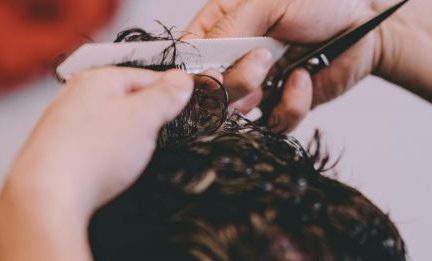 Trim Hair - From above of crop anonymous master cutting hair of male client in modern barbershop