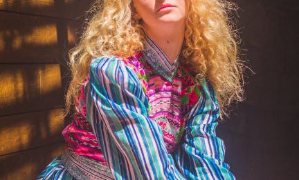 Fashion Capitals - Woman in Red and Blue Plaid Dress Shirt Sitting on Stairs